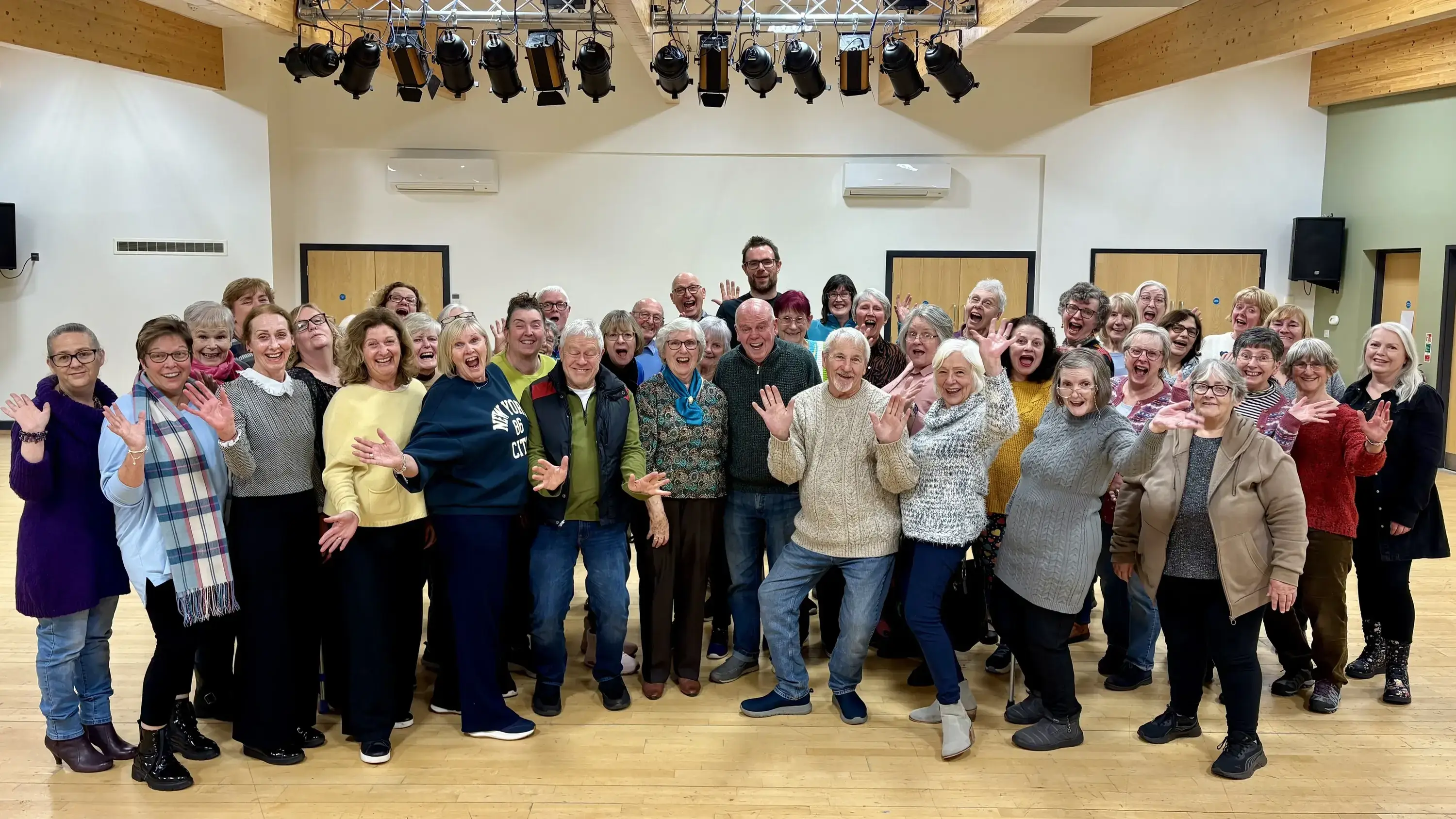 Members of Runcorn Community Choir standing together and smiling
